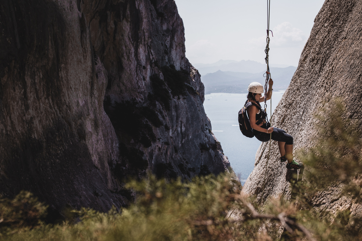 A Woman Rappelling with a Rope